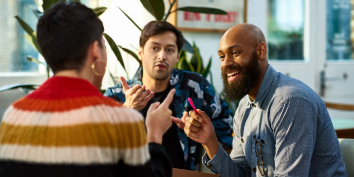 Multi ethnic group sharing ideas in office