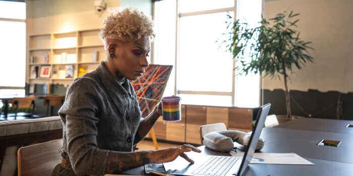 Mid adult businesswoman working with technology at coworking