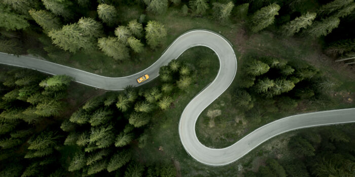Overhead view of car driving on s-shape mountain road, Giau Pass, Dolomites, Veneto, Italy