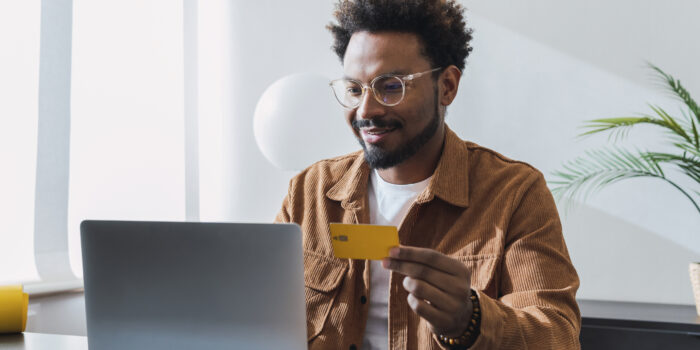 Smiling businessman making payment with credit card