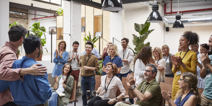 Multi-ethnic business people applauding after presentation. Happy male and female professionals are clapping in conference room. They are attending seminar.