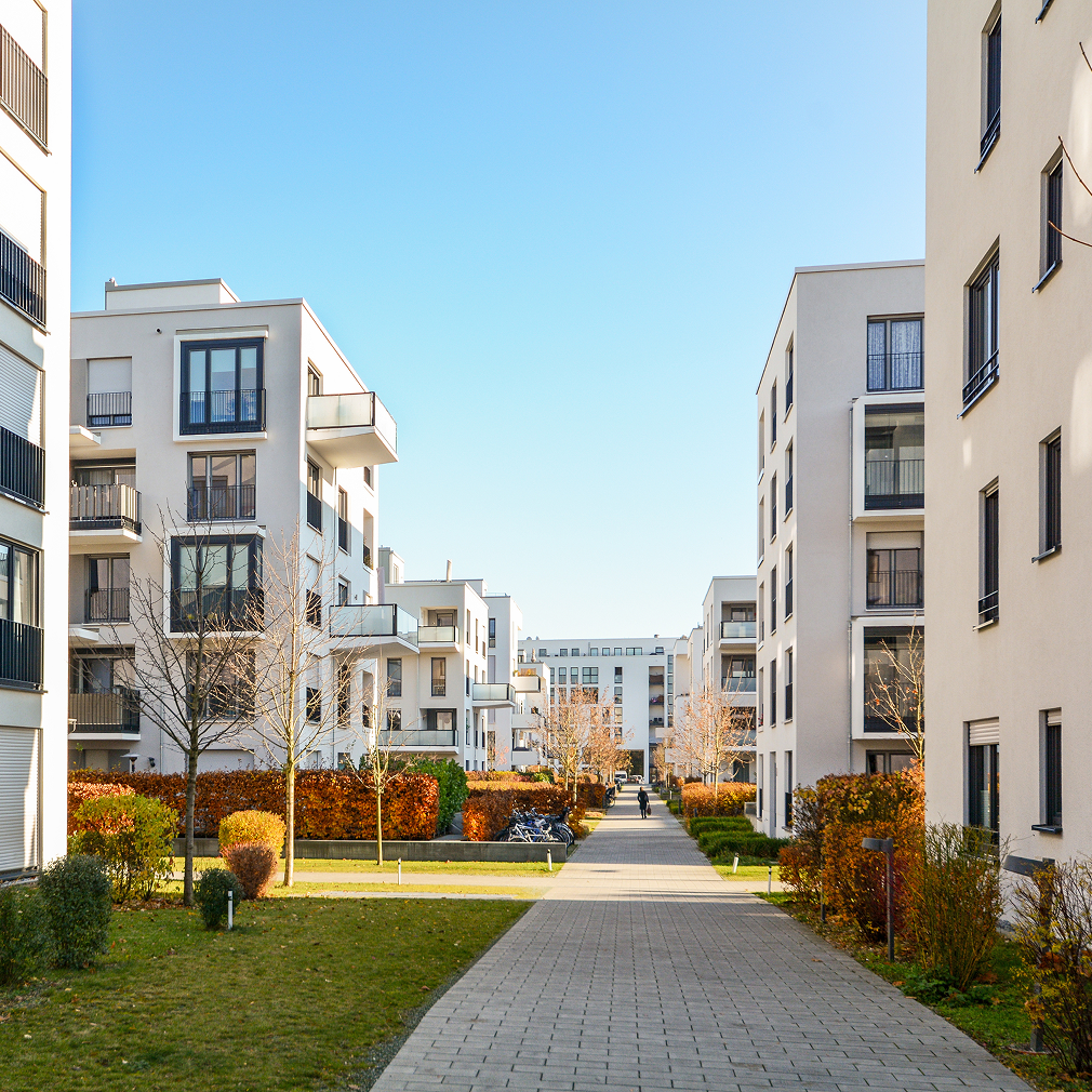 Four story condo buildings with landscaping
