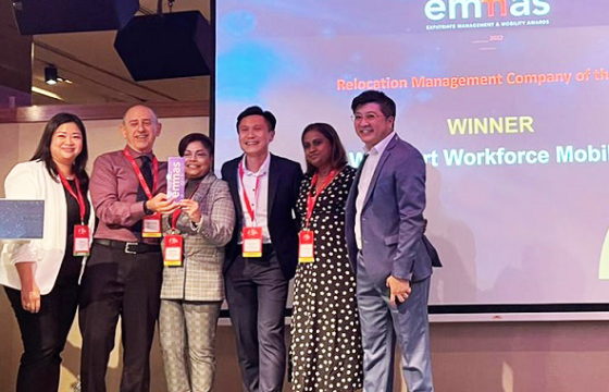 Group shown on stage holding an emmas trophy