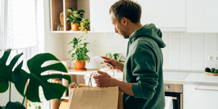 Man looking at grocery receipt