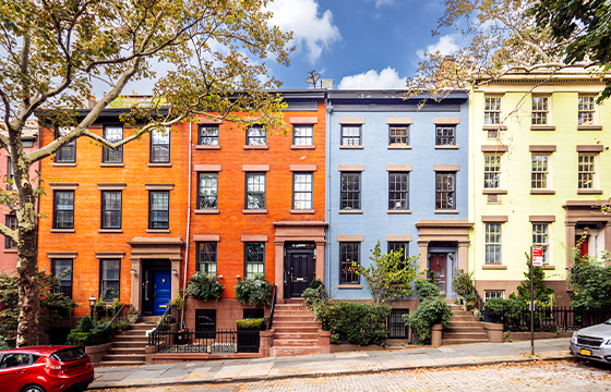 Global Housing Strategy Guide cover with an image of colorful row houses