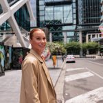 Professional walking through a modern Australian business district, representing Australia mobility trends and workforce strategy