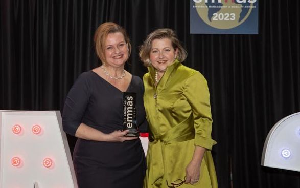 Two women holding emmas trophy at 2023 emmas
